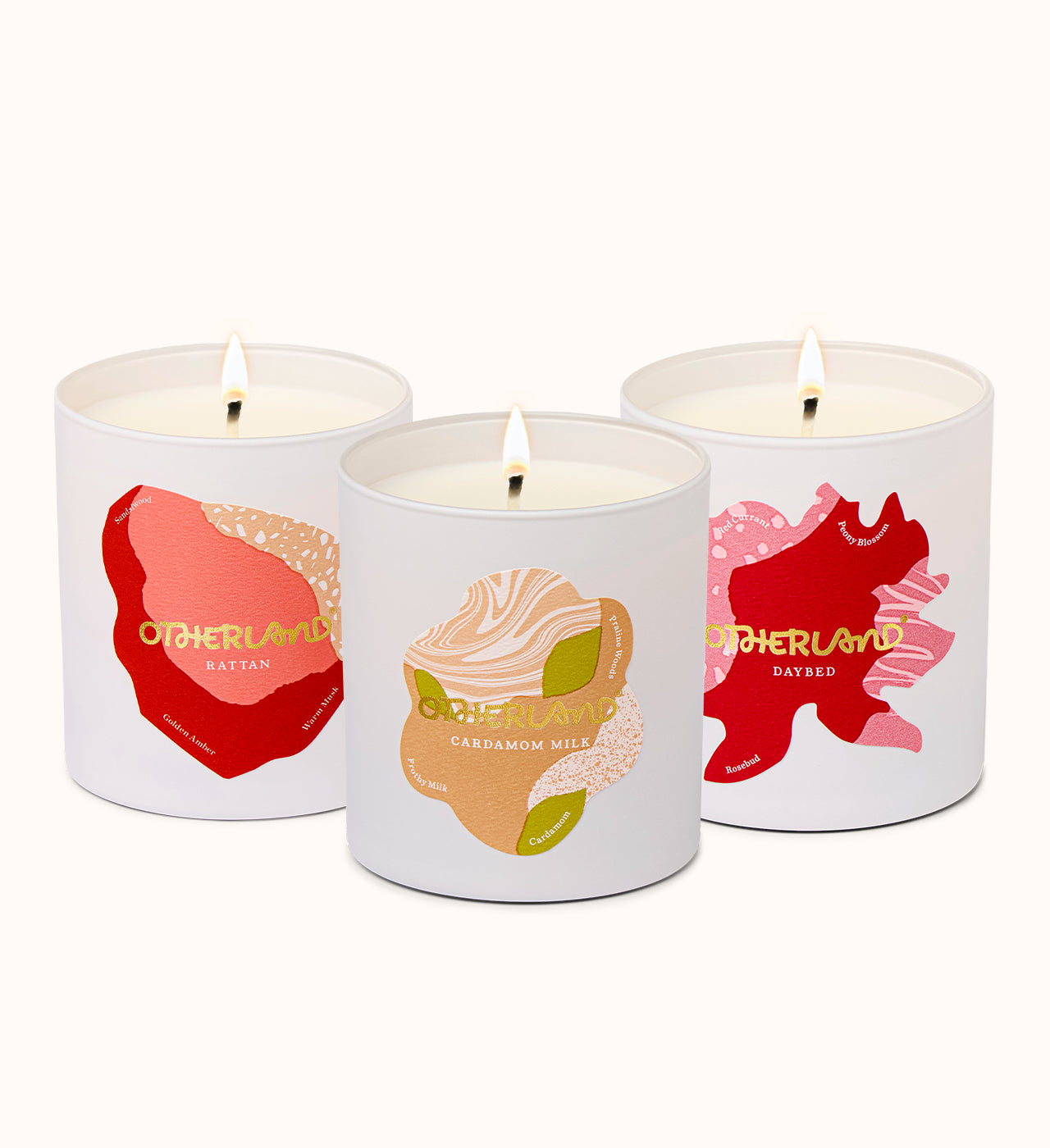 Three scented candles with colorful labels on a white background