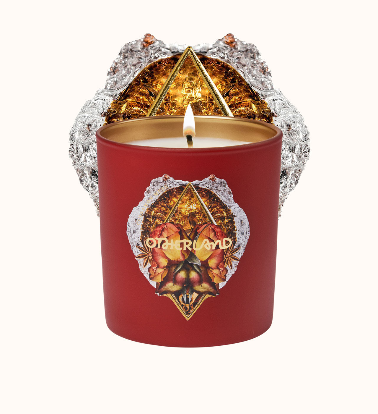 Red candle with decorative label and 'Otherland' branding on a white background