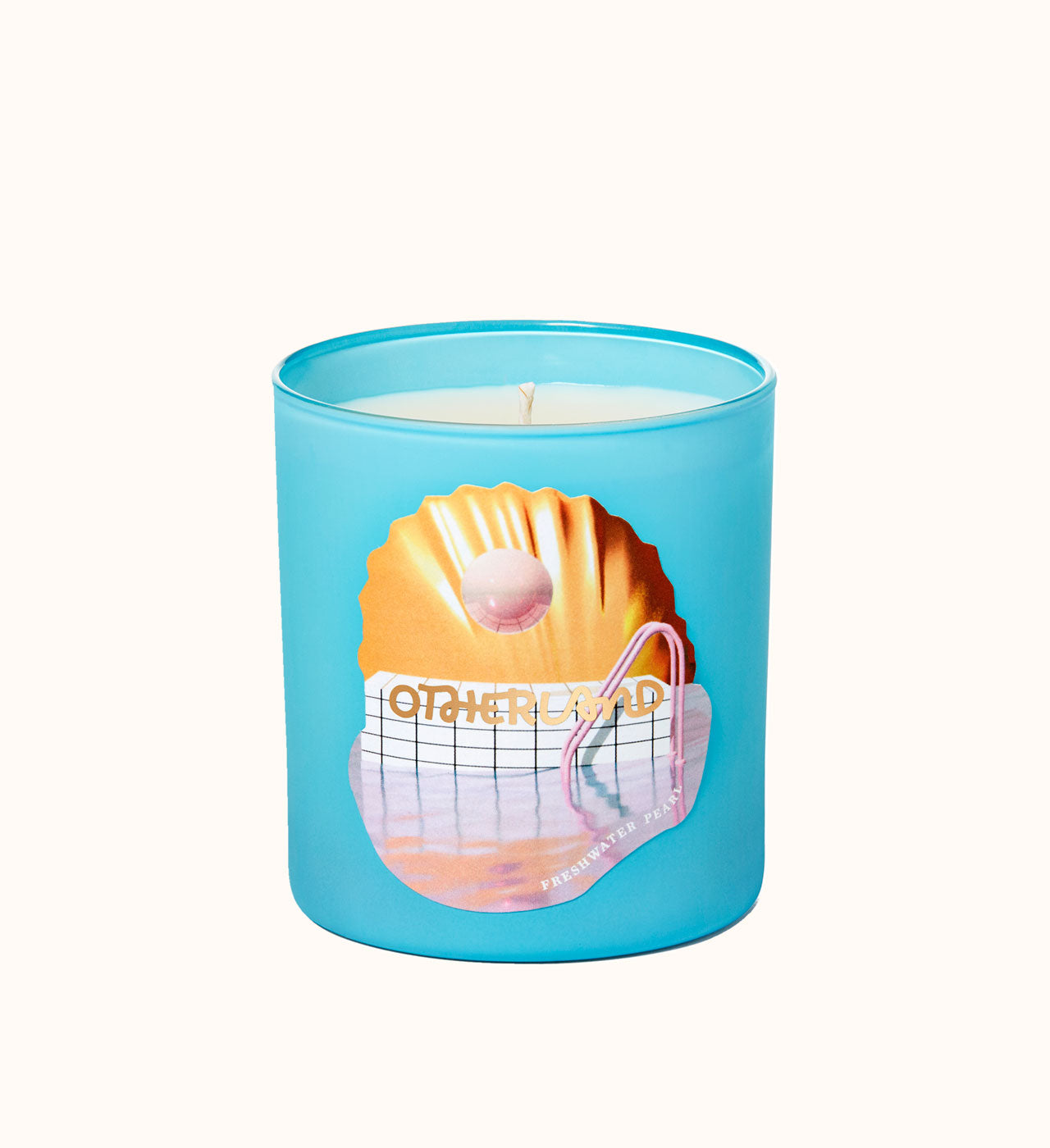 Blue candle with a shell design and 'Otherland' text on a white background