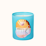 Blue candle with a shell design and 'Otherland' text on a white background
