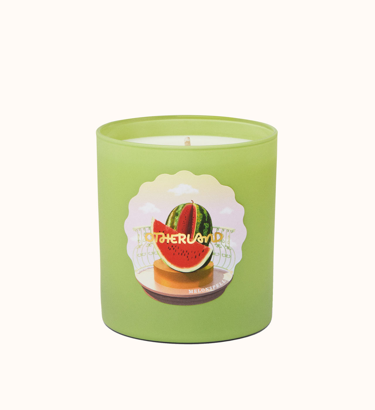 Green candle with watermelon design on a white background