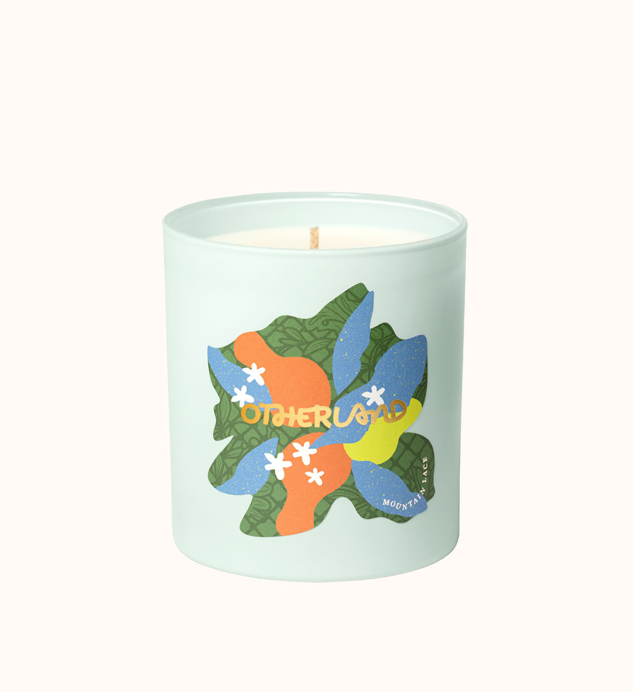 Light blue candle with colorful leaf design and 'Otherland' branding on a white background