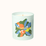 Light blue candle with colorful leaf design and 'Otherland' branding on a white background