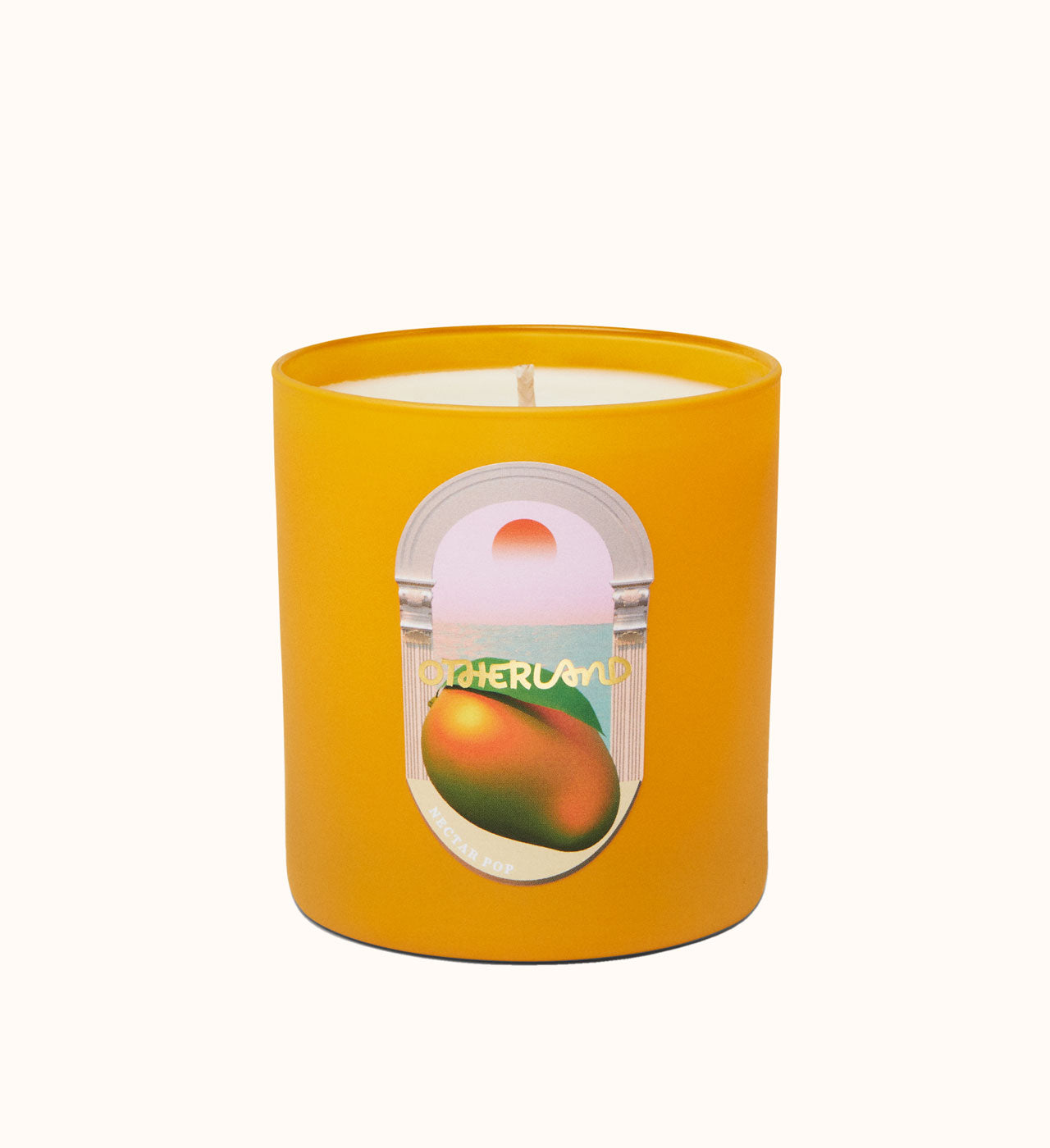 Yellow candle with a label featuring an orange on a white background
