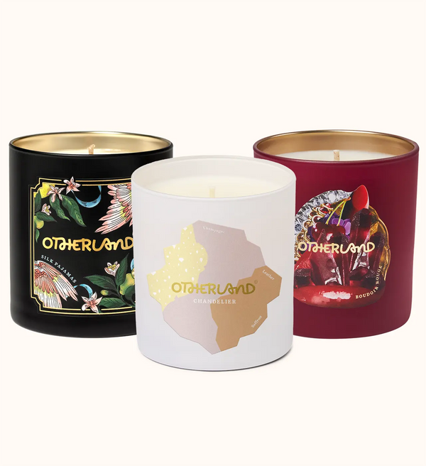 Three scented candles with 'Otherland' branding on a white background