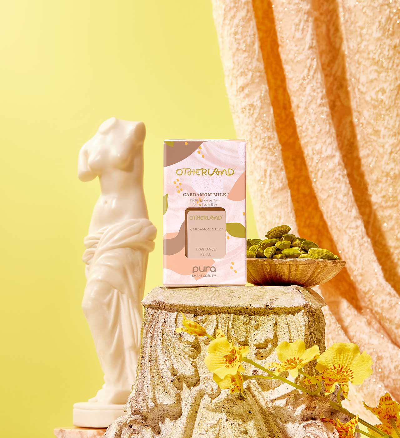 Pura refill product on a decorative stone pedestal with flowers and a statue against a yellow background